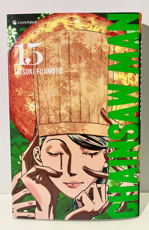 Couverture Chainsaw Man tome 15, personnage aux yeux fermés, fond végétal, titre en vert