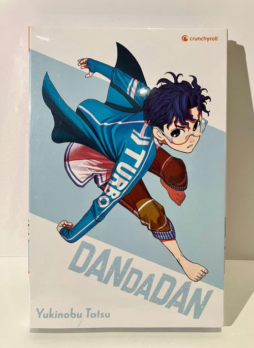 Couverture du manga Dandadan tome 6 édition collector avec personnage en tenue bleue, Crunchyroll