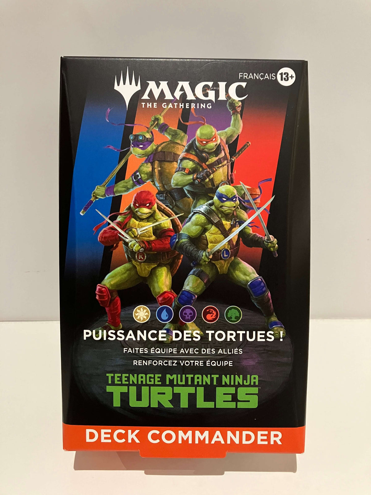 4 tortues ninja sont au milieu sur fond bleu, orange, violet et rouge