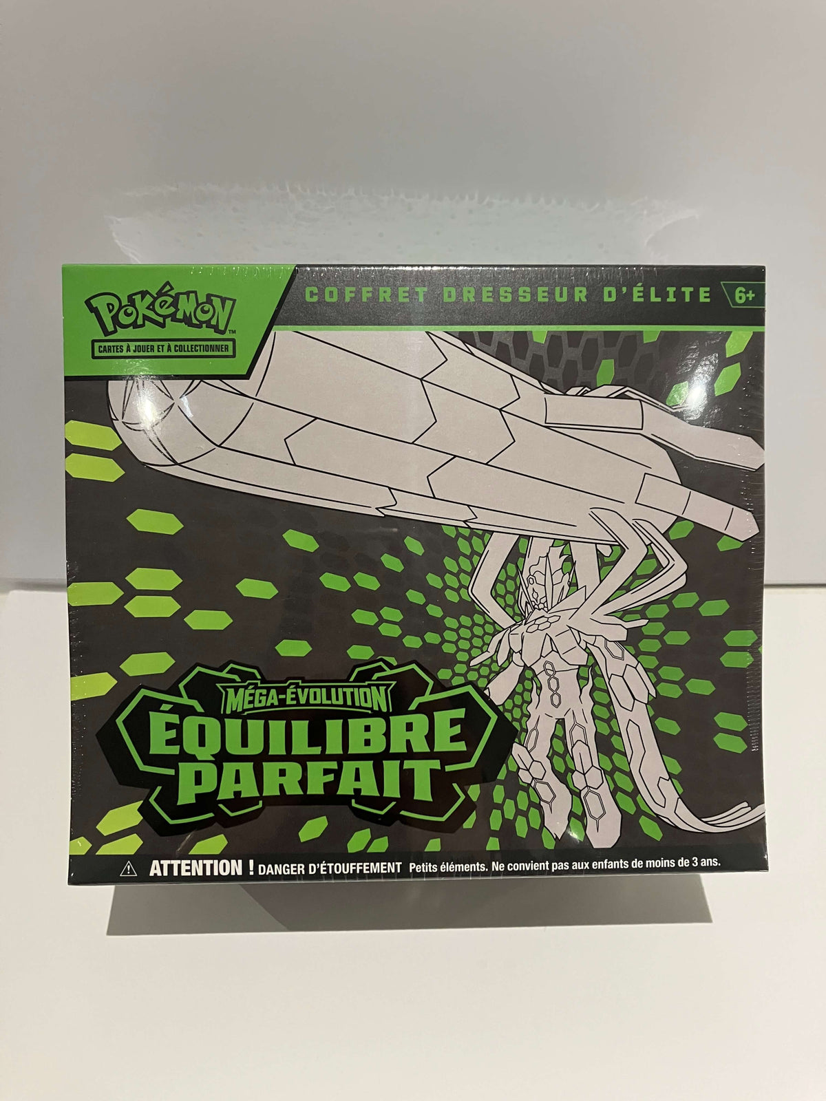 ETB Équilibre parfait avec un grand pokémon gris  sur fond noir et vert