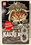Couverture manga Kaiju No 8 tome 6, personnage blond armé, sticker Dandadan, Naoya Matsumoto