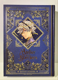 Couverture manga L'Atelier des Sorciers tome 2 édition grimoire, décor doré, portrait sorcier