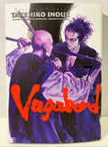 Couverture du manga Vagabond tome 7, duel de sabres entre deux guerriers, illustrée en violet.