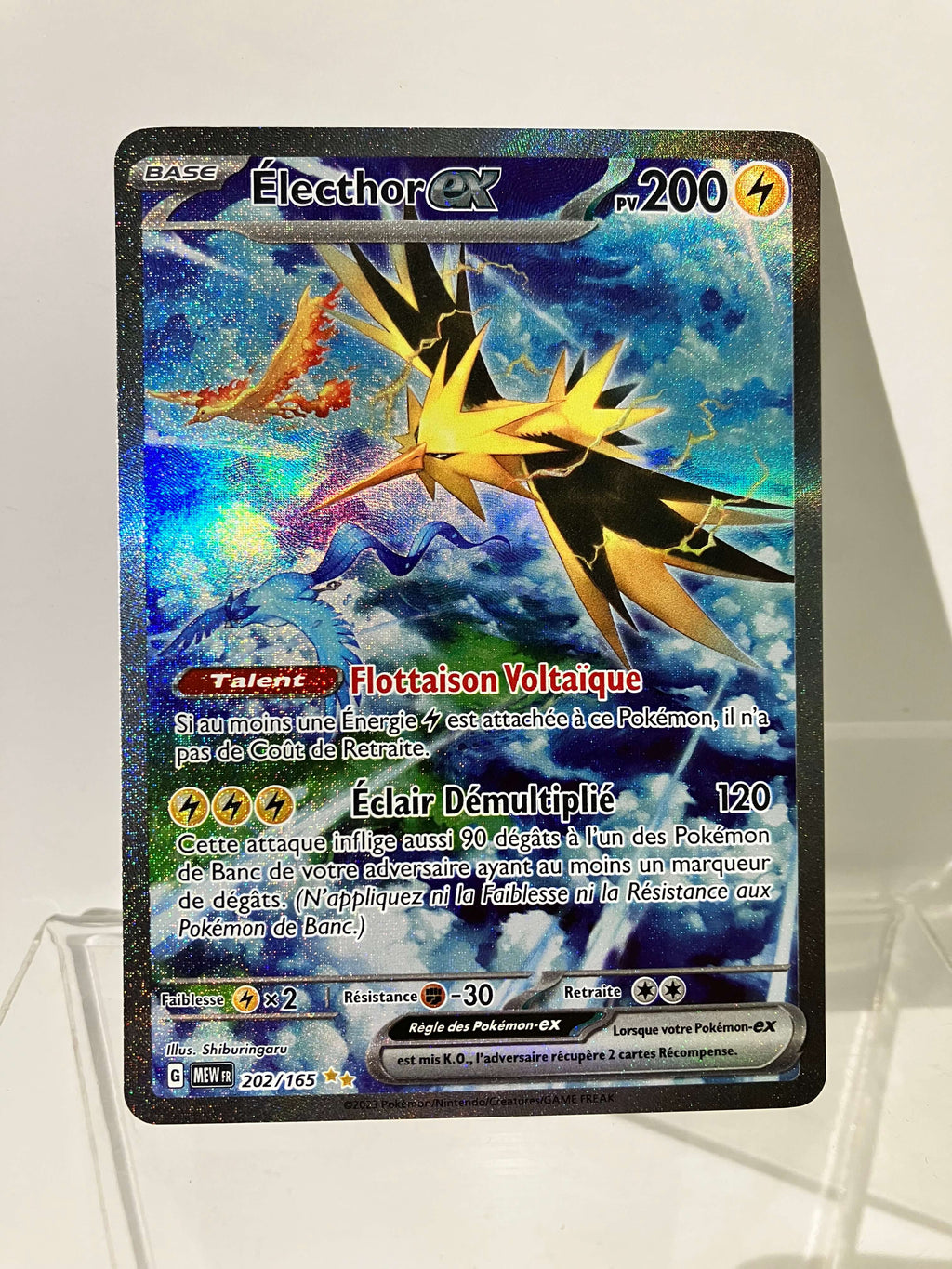 Carte Pokémon Électhor EX brillante, illustrant un oiseau électrique sur fond bleu